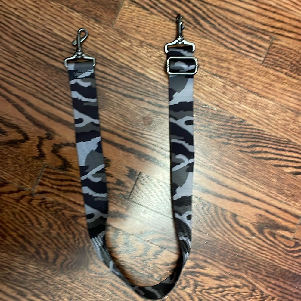 NWOT Adjustable strap w/clips on both ends. Maximum length approx. 26 inches.